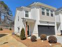 Charming townhome featuring a two-car garage, neutral paint, and well-maintained landscaping at 5576 Rockfern Drive, Lilburn, GA 30047