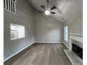 Spacious living room with high ceilings, modern fireplace, and view of the kitchen at 5961 Sherwood Trce, Stonecrest, GA 30038
