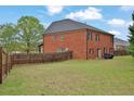 Spacious backyard featuring a well-maintained lawn and privacy fence at 2384 Allsborough Way, Dacula, GA 30019