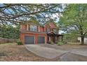 Charming two-story brick home with a well-maintained lawn and a two-car garage at 2384 Allsborough Way, Dacula, GA 30019
