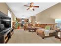 Spacious living room with a plush brown sofa and a view into the kitchen at 2384 Allsborough Way, Dacula, GA 30019