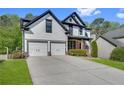 Inviting two-story home with a two-car garage and lush green lawn at 3085 Woodbridge Ln, Canton, GA 30114