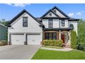 Charming two-story home with a well-kept lawn and a convenient two-car garage at 3085 Woodbridge Ln, Canton, GA 30114