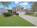 Charming two-story home with a well-maintained lawn, two-car garage, and inviting curb appeal at 2480 Sheldon Pl, Cumming, GA 30040