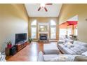 Bright living room with high ceilings, a stone fireplace, and large windows for natural light at 31 Vine Creek Ln, Acworth, GA 30101