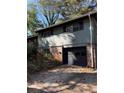 Exterior view with a brick base and a black garage door at 865 Cherrydale Ln, Woodstock, GA 30189