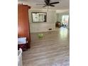 View of the living room with wood floors, ceiling fan and large mirror at 865 Cherrydale Ln, Woodstock, GA 30189