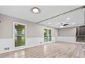 Bright and airy living area featuring wood floors, wainscoting, recessed lighting and plenty of natural light from exterior windows at 2617 Peggy Sue Ln, Morrow, GA 30260