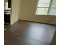 Bright living room featuring hardwood floors, a large window, and access to other parts of the home at 6344 Fitzgerald Ln, Austell, GA 30168