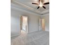 Bedroom with doors leading to bathroom and closet areas, neutral paint and carpet at 1431 Winding Ridge Trl, Buford, GA 30548