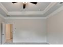 Spacious carpeted bedroom featuring a ceiling fan and neutral color palette at 1431 Winding Ridge Trl, Buford, GA 30548