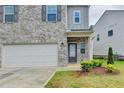 Charming brick home featuring a two-car garage and welcoming front entrance at 1431 Winding Ridge Trl, Buford, GA 30548
