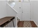 Entryway features modern console table and stairs, highlighted by neutral walls at 331 Parkview Manor Dr, Tucker, GA 30084