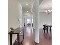 Spacious hallway with hardwood floors, white trim, and view into adjacent rooms at 3360 Camellia Ln, Suwanee, GA 30024