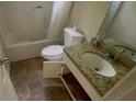 Bathroom with vinyl flooring, tub with shower, toilet and vanity with granite countertop at 100 Waters Edge Dr, Locust Grove, GA 30248