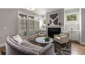 Elegant living room featuring a fireplace, plantation shutters, and stylish furnishings at 111 Brighton Blvd, Woodstock, GA 30188