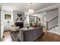 Spacious living room with fireplace, neutral decor, and an open layout to the dining area at 111 Brighton Blvd, Woodstock, GA 30188