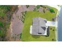 Aerial view showcases a well-maintained lawn, a patio, and the roof of this gorgeous home at 1964 Crosswaters Dr, Dacula, GA 30019