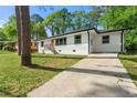 Freshly painted white brick home with a neatly kept lawn and a convenient concrete driveway at 2146 Trailwood Rd, Decatur, GA 30032