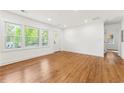 Bright living room with hardwood floors, large windows, and freshly painted white walls at 2146 Trailwood Rd, Decatur, GA 30032