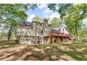 Rear view of home with a stone foundation, deck, and walkout basement at 4336 Yancey Rd, Douglasville, GA 30135