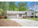 Exterior of the house, highlighting the driveway and landscaping around the house at 5286 Westhill Dr, Norcross, GA 30071