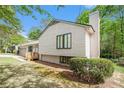 A sunny view of a two-story home, showcasing its unique architecture and landscaping at 5286 Westhill Dr, Norcross, GA 30071