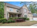 Charming two-story home with a well-manicured lawn, a two-car garage, and a covered front porch at 3907 Fellowship Dr, Buford, GA 30519