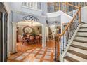 Grand foyer featuring staircase, dining room view, and unique tile and hardwood flooring design at 3907 Fellowship Dr, Buford, GA 30519