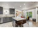 Updated kitchen with island, gray cabinets and views to the dining area at 1899 Cooper Landing Se Dr, Smyrna, GA 30080