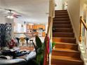 Open concept living room and kitchen with hardwood floors and staircase to the second floor at 2896 Spence Ct, Dacula, GA 30019