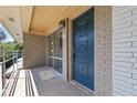 Apartment entryway featuring a blue door, brick wall, and covered porch area at 3046 Briarcliff Ne Rd # 7, Atlanta, GA 30329