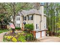 Two-story home with attached two car garage, and nicely landscaped front yard at 1209 Fern Hollow Dr, Woodstock, GA 30189