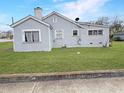 View of the rear exterior, showcasing the structure and lawn at 1683 Candler Rd, Decatur, GA 30032