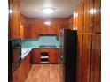 A cozy kitchen featuring wooden cabinets, appliances and laminate countertops at 4141 Fredericksburg Dr, College Park, GA 30337