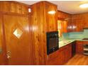 The kitchen has a classic layout, wooden cabinets and appliances at 4141 Fredericksburg Dr, College Park, GA 30337