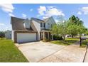 Traditional two-story home featuring a two-car garage, long driveway, and manicured lawn at 1016 Borrington Ln, Stockbridge, GA 30281