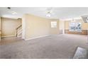 Spacious living room with neutral carpeting, staircase, and a window with natural light at 1016 Borrington Ln, Stockbridge, GA 30281