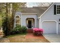The property includes a front door, an arched window, and a two-car garage at 3711 Spinnaker Cir, Alpharetta, GA 30005