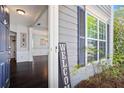 Inviting entryway showcasing hardwood floors, decorative pillars, and a glimpse into the formal dining room at 512 Watercress Dr, Woodstock, GA 30188