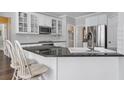 Kitchen with stainless steel appliances, granite countertop island and hardwood flooring at 625 Park Creek Trce, Alpharetta, GA 30005