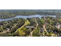 Aerial shot of beautiful home nestled in a lush, green community near a lake and golf course at 1010 Lake Shore Overlook, Alpharetta, GA 30005
