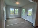 Bright sunroom with ample natural light, offering a serene space with views of the backyard at 1636 Tide Mill Rd, Cumming, GA 30040