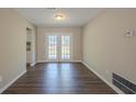 Bright dining area featuring hardwood floors and french doors at 6520 Emerald Pointe Cir, Atlanta, GA 30349