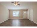 Inviting living room with hardwood floors, natural light, and neutral paint at 6520 Emerald Pointe Cir, Atlanta, GA 30349