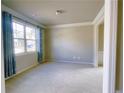 Bright living room featuring ample natural light, neutral paint, and new carpet at 556 Paden Ridge Way, Lawrenceville, GA 30044