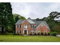 Charming brick residence with a lush green lawn, showcasing timeless design and inviting curb appeal in a residential setting at 2238 Roseberry Ln, Grayson, GA 30017