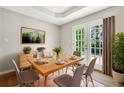 Cozy dining room features a wooden table, modern chairs, and a door to the backyard at 7194 Oakwood Cir, Rex, GA 30273