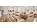 Bright, staged living room with hardwood floors, large windows and comfortable seating at 958 Winburn Dr, Atlanta, GA 30344