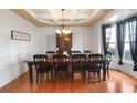 Formal dining room with coffered ceiling, chandelier, and large window providing ample natural light at 415 Eldridge Dr, Suwanee, GA 30024